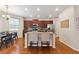Open-concept kitchen with island seating, granite countertops, stainless steel appliances, and adjacent breakfast nook at 6202 Oakdale Ridge Se Ct, Mableton, GA 30126