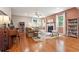 Bright living room featuring hardwood floors, fireplace, and a ceiling fan to circulate airflow at 6202 Oakdale Ridge Se Ct, Mableton, GA 30126