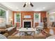 A cozy living room with a fireplace and multiple windows creates a warm atmosphere for entertaining at 6202 Oakdale Ridge Se Ct, Mableton, GA 30126
