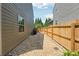 Narrow side yard with gravel, stepping stones, and a wood fence at 6202 Oakdale Ridge Se Ct, Mableton, GA 30126