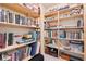 Closet with wooden shelving filled with books and decor items, perfect for organization and storage at 6202 Oakdale Ridge Se Ct, Mableton, GA 30126
