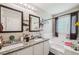 Bright bathroom with granite double vanity, mirrors, and soaking tub at 876 Ashton Oak Cir, Stone Mountain, GA 30083