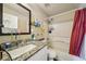 Bathroom boasts a granite countertop, a tub, and updated fixtures at 876 Ashton Oak Cir, Stone Mountain, GA 30083