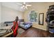 This bedroom boasts a window, wood flooring, and modern ceiling fan at 876 Ashton Oak Cir, Stone Mountain, GA 30083