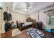The large bedroom has wood floors and a modern ceiling fan at 876 Ashton Oak Cir, Stone Mountain, GA 30083
