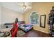 Cozy bedroom features a ceiling fan, window, and wood-look floors at 876 Ashton Oak Cir, Stone Mountain, GA 30083