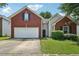 Charming brick and vinyl home with a two-car garage and well-maintained lawn at 876 Ashton Oak Cir, Stone Mountain, GA 30083