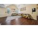 Open living room featuring hardwood floors, vaulted ceiling, and large windows at 876 Ashton Oak Cir, Stone Mountain, GA 30083