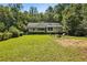 Expansive backyard featuring a fire pit and plenty of space for outdoor activities at 2121 Jep Wheeler Rd, Woodstock, GA 30188