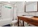 Modern bathroom with subway tile, a wooden vanity, and a combined shower and tub for a spa-like feel at 2121 Jep Wheeler Rd, Woodstock, GA 30188