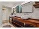 Bathroom featuring dual sinks, wood countertop, vintage medicine cabinet and shiplap walls at 2121 Jep Wheeler Rd, Woodstock, GA 30188
