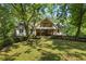 Charming home exterior with a front porch, balcony, and lush landscaping at 2121 Jep Wheeler Rd, Woodstock, GA 30188
