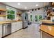 Modern kitchen featuring stainless steel appliances, wood countertops, and abundant natural light from a large window at 2121 Jep Wheeler Rd, Woodstock, GA 30188