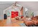 Living room with wood floors, neutral walls, red cabinet, white couch, and gym equipment at 2121 Jep Wheeler Rd, Woodstock, GA 30188