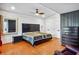 Bedroom with wood floors, neutral walls, dual closets, and dark wood furniture at 2121 Jep Wheeler Rd, Woodstock, GA 30188