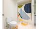 Bathroom featuring toilet, a walk-in shower with a graphic shower curtain, and tiled floors at 225 E Ponce De Leon Ave # 310, Decatur, GA 30030