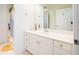 Bathroom with white cabinets, white marble countertop, and a large mirror at 225 E Ponce De Leon Ave # 310, Decatur, GA 30030
