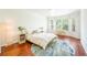 Bright bedroom with hardwood floors, a decorative rug, and a floor lamp at 225 E Ponce De Leon Ave # 310, Decatur, GA 30030