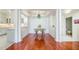 Dining room with hardwood floors, a green chandelier, and access to the kitchen and bathroom at 225 E Ponce De Leon Ave # 310, Decatur, GA 30030