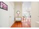 Hallway showcasing hardwood floors, a stylish mirror, and access to the living room at 225 E Ponce De Leon Ave # 310, Decatur, GA 30030
