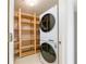 Laundry room area with storage shelves and front loading stacked washer and dryer at 225 E Ponce De Leon Ave # 310, Decatur, GA 30030