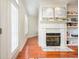 Living room showcasing a fireplace, built-in shelves, and natural light from the french doors at 225 E Ponce De Leon Ave # 310, Decatur, GA 30030