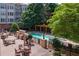 Community pool featuring lounge chairs, tables, and a pergola at 225 E Ponce De Leon Ave # 310, Decatur, GA 30030