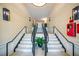 Elegant staircase featuring tile steps, ornate railings, and decorative wall sconces at 225 E Ponce De Leon Ave # 310, Decatur, GA 30030