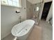 Luxurious bathroom featuring a soaking tub, glass-enclosed shower, and modern fixtures at 2873 Shoals Hill Ct, Dacula, GA 30019
