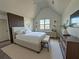 Comfortable bedroom featuring a vaulted ceiling, large windows, and stylish decor at 2873 Shoals Hill Ct, Dacula, GA 30019
