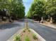 Gated entrance to community with stone pillars and mature trees lining the road at 2873 Shoals Hill Ct, Dacula, GA 30019