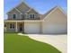 Charming two-story home featuring a two-car garage, well-maintained lawn, and a welcoming front entrance at 2873 Shoals Hill Ct, Dacula, GA 30019