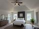 Tranquil main bedroom with tray ceilings, a sitting area, and natural light at 2873 Shoals Hill Ct, Dacula, GA 30019