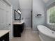 Bright bathroom with a soaking tub, vanity with double sinks and a shower at 4673 Jefferson Township Pl, Marietta, GA 30066