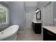 Elegant bathroom with freestanding tub, vanity, and natural light from the window at 4673 Jefferson Township Pl, Marietta, GA 30066