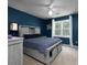 Blue bedroom with modern farmhouse style bed and nightstand and a window that lets in plenty of natural light at 4673 Jefferson Township Pl, Marietta, GA 30066
