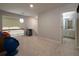 Bonus room with soft gray walls and carpet, featuring an open railing and a doorway leading to a bathroom at 4673 Jefferson Township Pl, Marietta, GA 30066