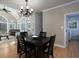 Well-lit dining area with dark wood table set, chandelier, and large windows at 4673 Jefferson Township Pl, Marietta, GA 30066