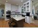 Spacious kitchen featuring island with seating, modern appliances, and hardwood floors at 4673 Jefferson Township Pl, Marietta, GA 30066