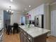 Open-concept kitchen and dining area with granite island, stainless appliances, and hardwood floors at 4673 Jefferson Township Pl, Marietta, GA 30066