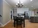 Modern kitchen with dining area, stainless steel appliances, granite countertops, and wood flooring at 4673 Jefferson Township Pl, Marietta, GA 30066