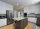 Bright kitchen featuring an island with seating, stainless steel appliances, and white cabinets at 4673 Jefferson Township Pl, Marietta, GA 30066