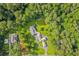 Stunning aerial view of a home surrounded by lush trees and greenery at 4847 Lakewood Dr, Acworth, GA 30101
