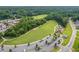 Expansive aerial view of the park with lush green fields, wooded areas, parking, and recreational amenities at 4847 Lakewood Dr, Acworth, GA 30101