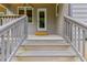 Back porch featuring stairs, a light wood railing and door leading inside the house at 4847 Lakewood Dr, Acworth, GA 30101
