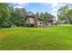 Sprawling backyard with lush green lawn and beautiful landscaping at 4847 Lakewood Dr, Acworth, GA 30101