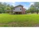 Spacious backyard of the home with a large green lawn and mature trees at 4847 Lakewood Dr, Acworth, GA 30101