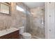 Bright bathroom featuring a modern vanity, toilet, and glass-enclosed shower with niche at 4847 Lakewood Dr, Acworth, GA 30101