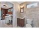 Neutral tiled bathroom with modern vanity and updated fixtures, along with a laundry area at 4847 Lakewood Dr, Acworth, GA 30101