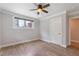 Bedroom featuring wood-look floors, gray walls, ceiling fan, and built in closet at 4847 Lakewood Dr, Acworth, GA 30101